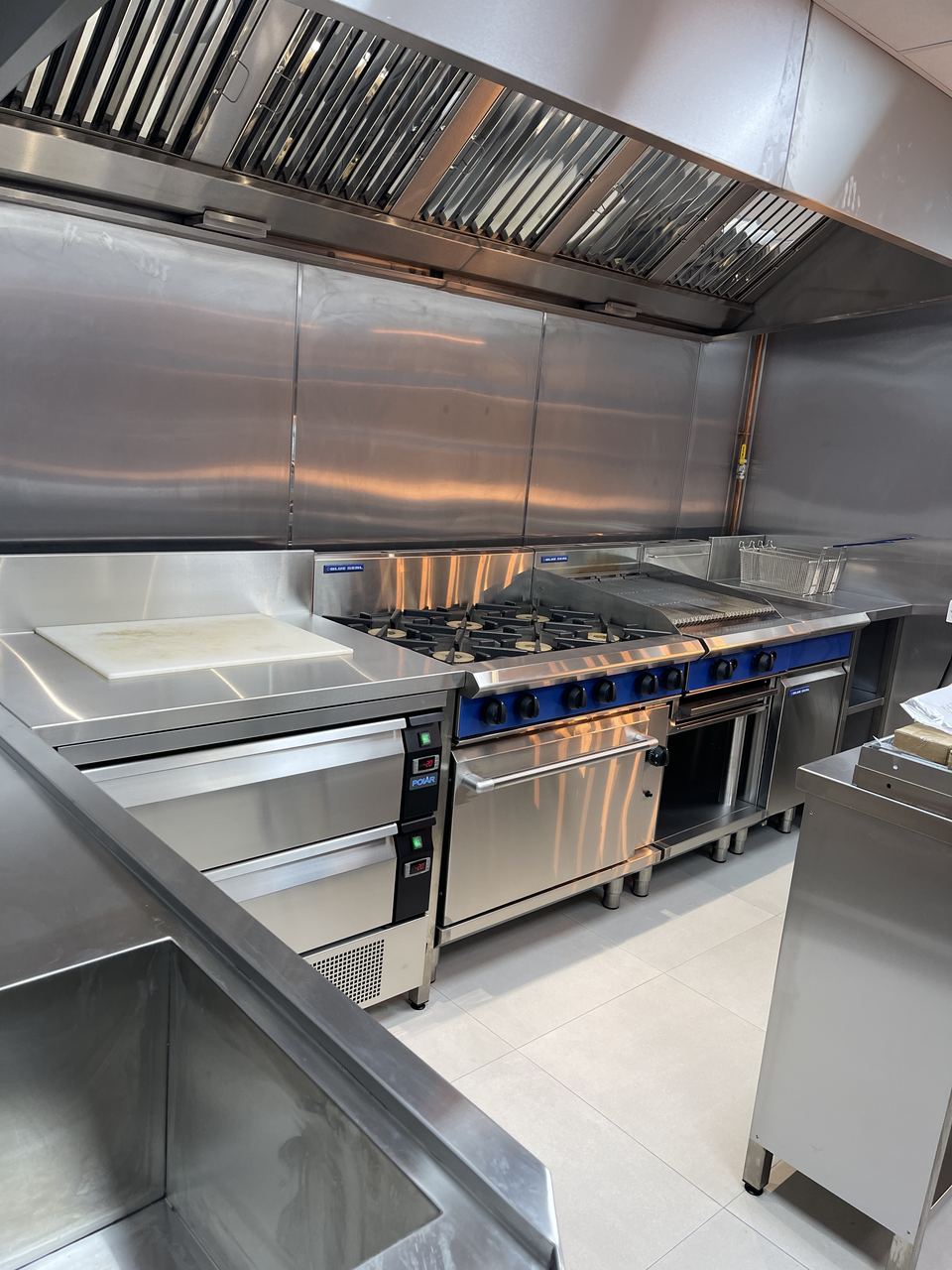 Gusto D'Italia: stainless commercial kitchen line with extraction canopy